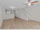 Open-concept living area with hardwood floors and a staircase at 12516 Hennigan Place Ln, Charlotte, NC 28214