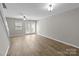 Spacious living room features hardwood floors, ceiling fans, and natural light at 12516 Hennigan Place Ln, Charlotte, NC 28214