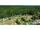 An aerial view of homes in a wooded neighborhood, showing the community layout and surrounding trees at 135 Burton Hills Cir, Gastonia, NC 28054