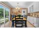 Bright dining area featuring a sliding glass door and modern lighting fixture at 135 Burton Hills Cir, Gastonia, NC 28054