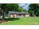 Classic brick home featuring a welcoming porch and a lush green lawn at 135 Burton Hills Cir, Gastonia, NC 28054