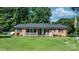 Traditional brick home with a cozy front porch and well-maintained lawn at 135 Burton Hills Cir, Gastonia, NC 28054
