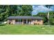 Traditional brick home with a cozy front porch and well-maintained lawn at 135 Burton Hills Cir, Gastonia, NC 28054