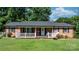 Attractive brick house with a quaint porch and manicured front lawn at 135 Burton Hills Cir, Gastonia, NC 28054