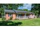 Charming brick house with a covered front porch and manicured landscaping at 135 Burton Hills Cir, Gastonia, NC 28054