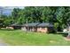 Charming brick home featuring a well-manicured lawn and inviting front porch at 135 Burton Hills Cir, Gastonia, NC 28054