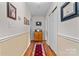 Inviting hallway with wainscoting, wood floors, and stylish decor provides a warm welcome at 135 Burton Hills Cir, Gastonia, NC 28054