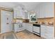 Bright white kitchen featuring white appliances, ample cabinetry, and neutral countertops at 135 Burton Hills Cir, Gastonia, NC 28054