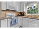 Bright kitchen featuring white cabinets, modern appliances, and cozy decor at 135 Burton Hills Cir, Gastonia, NC 28054
