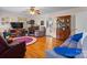 Cozy living room featuring hardwood floors, comfortable seating, and a vintage hutch, radiating warmth and charm at 135 Burton Hills Cir, Gastonia, NC 28054