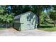 Green shed with double doors and gray trim in backyard at 135 Burton Hills Cir, Gastonia, NC 28054