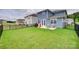 Spacious backyard featuring lush green grass, patio, and black metal fence, perfect for outdoor activities at 150 Bezelle Ave, York, SC 29745
