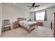 Bright bedroom with a ceiling fan, window, and a classic wooden furniture set at 150 Bezelle Ave, York, SC 29745