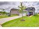 Charming two-story home with a well-maintained lawn, a two-car garage, and inviting curb appeal at 150 Bezelle Ave, York, SC 29745
