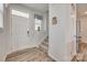 Bright foyer with wood-look floors, staircase, coat closet, and front door with sidelight at 150 Bezelle Ave, York, SC 29745