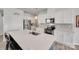Kitchen with stainless steel appliances, white cabinets, gray backsplash, and large center island at 150 Bezelle Ave, York, SC 29745