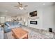Open-concept living room with a modern fireplace, ceiling fan, and hardwood floors leading into the kitchen at 150 Bezelle Ave, York, SC 29745