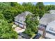 Aerial view of the home with three-car garage, balcony, and lush surrounding trees at 15209 Loire Valley St, Charlotte, NC 28277