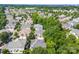 Scenic aerial view of a residential neighborhood with lush trees and well-maintained homes at 15209 Loire Valley St, Charlotte, NC 28277