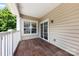 Covered balcony with tile flooring and white railing, perfect for enjoying the outdoors at 15209 Loire Valley St, Charlotte, NC 28277