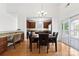 This dining room has hardwood floors, a modern chandelier, and easy access to the kitchen and outdoor patio at 15209 Loire Valley St, Charlotte, NC 28277
