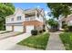 Charming townhome features a brick facade, covered porch, and attached garages at 15209 Loire Valley St, Charlotte, NC 28277