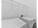 Convenient laundry room with washer, dryer, and overhead shelving for storage at 15209 Loire Valley St, Charlotte, NC 28277
