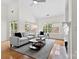 Bright and spacious living room featuring a fireplace, large windows, and comfortable seating for relaxing and entertaining at 15209 Loire Valley St, Charlotte, NC 28277