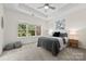 This main bedroom has a ceiling fan, tray ceilings, a large window, and plush carpet at 15209 Loire Valley St, Charlotte, NC 28277