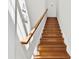 Wooden stairway with handrail and bright natural lighting at 15209 Loire Valley St, Charlotte, NC 28277