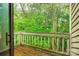 Balcony view surrounded by lush greenery and a wooded tree canopy at 1606 Sharon W Rd # 40, Charlotte, NC 28210