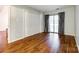 Bedroom with hardwood floors, large closet, and sliding glass doors to the balcony at 1606 Sharon W Rd # 40, Charlotte, NC 28210