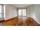 Bedroom with hardwood floors, large sliding glass doors to the outside balcony and bright interior at 1606 Sharon W Rd # 40, Charlotte, NC 28210