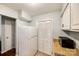 A kitchen area featuring white appliances and cabinets, with tiled floors, and pantry at 1606 Sharon W Rd # 40, Charlotte, NC 28210