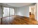 Open living room features hardwood floors and a sliding glass door to a balcony at 1606 Sharon W Rd # 40, Charlotte, NC 28210