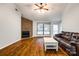 Cozy living room featuring a fireplace, hardwood floors, and natural light from large windows at 1606 Sharon W Rd # 40, Charlotte, NC 28210