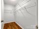 Spacious walk-in closet with ample shelving for storage and hardwood floors at 1606 Sharon W Rd # 40, Charlotte, NC 28210