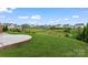 Spacious backyard featuring a well-manicured lawn, mature trees, and a scenic view at 17231 Rider Wood Ln, Charlotte, NC 28278