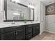 Modern bathroom with dual sinks, large mirror, and sleek fixtures at 17231 Rider Wood Ln, Charlotte, NC 28278
