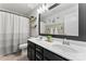 Elegant bathroom features a double vanity, ample mirror, and a stylish shower curtain at 17231 Rider Wood Ln, Charlotte, NC 28278