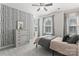 Bright bedroom offers a modern accent wall, plush carpeting, and two sunny windows at 17231 Rider Wood Ln, Charlotte, NC 28278