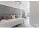 Neutral bedroom features stylish gray paneled accent wall, sleek ceiling fan, and cozy daybed at 17231 Rider Wood Ln, Charlotte, NC 28278