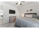 Comfortable bedroom featuring soft gray tones, a ceiling fan, and stylish furnishings at 17231 Rider Wood Ln, Charlotte, NC 28278