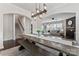 Elegant dining room with a large table, modern lighting, and an open view to the spacious living room at 17231 Rider Wood Ln, Charlotte, NC 28278