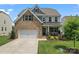 Charming two-story home featuring a brick facade, attached garage, manicured lawn and covered porch, located in a desirable neighborhood at 17231 Rider Wood Ln, Charlotte, NC 28278
