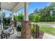 Inviting front porch adorned with potted plants, chairs, and brick columns, providing a cozy outdoor space at 17231 Rider Wood Ln, Charlotte, NC 28278