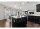 Kitchen with island, granite countertops, stainless appliances and view of dining area and living room at 17231 Rider Wood Ln, Charlotte, NC 28278