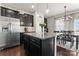 Eat-in kitchen with stainless appliances, granite countertops, and adjacent dining area with deck access at 17231 Rider Wood Ln, Charlotte, NC 28278