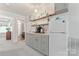 Convenient kitchenette with gray cabinets, mini-fridge, and a stylish tiled backsplash at 17231 Rider Wood Ln, Charlotte, NC 28278