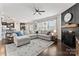 Open-concept living room featuring a large sectional sofa, fireplace, hardwood floors, and plenty of natural light at 17231 Rider Wood Ln, Charlotte, NC 28278